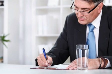 Businessman with document, signing a contract with pen
